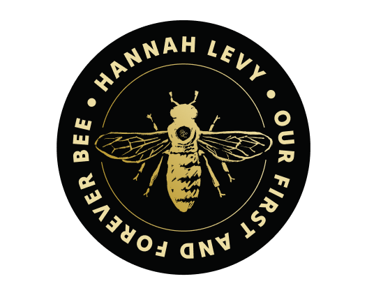 A gold bee illustration is centered on a black circle. Around the bee, gold text reads: HANNAH LEVY • OUR FIRST AND FOREVER BEE, celebrating her role in public affairs at Beekeeper Group.